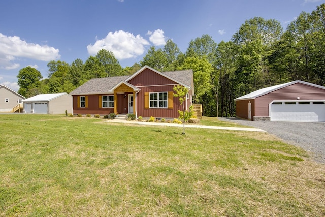 ranch-style home featuring a detached garage, an outdoor structure, and a front yard