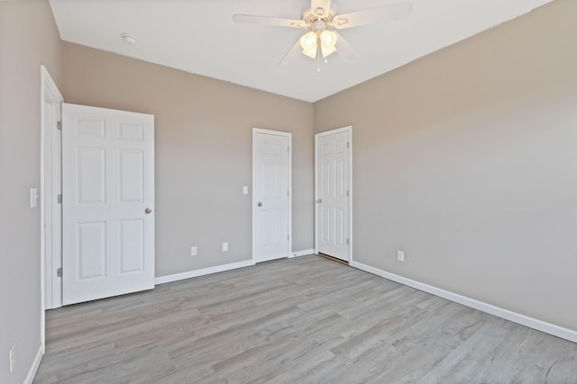 unfurnished bedroom with ceiling fan and light wood-type flooring