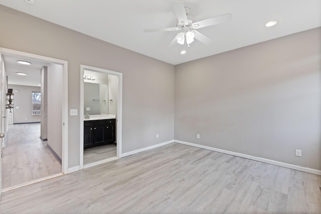 unfurnished room featuring ceiling fan, sink, and light hardwood / wood-style floors