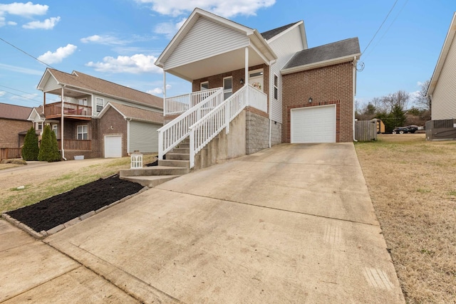 view of front facade with a porch, a garage, and a front lawn