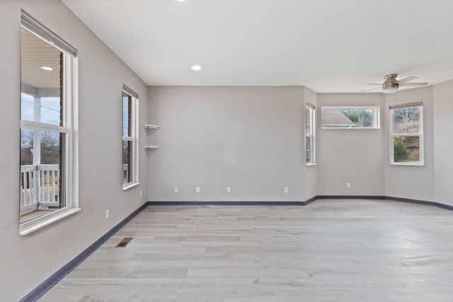 unfurnished room featuring ceiling fan and light wood-type flooring