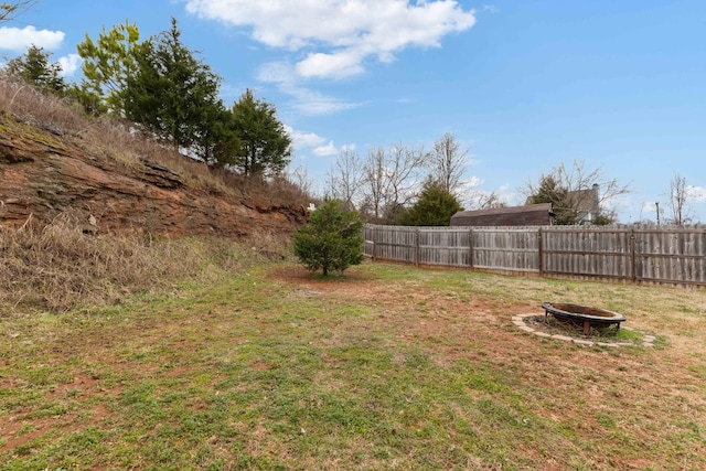 view of yard with an outdoor fire pit