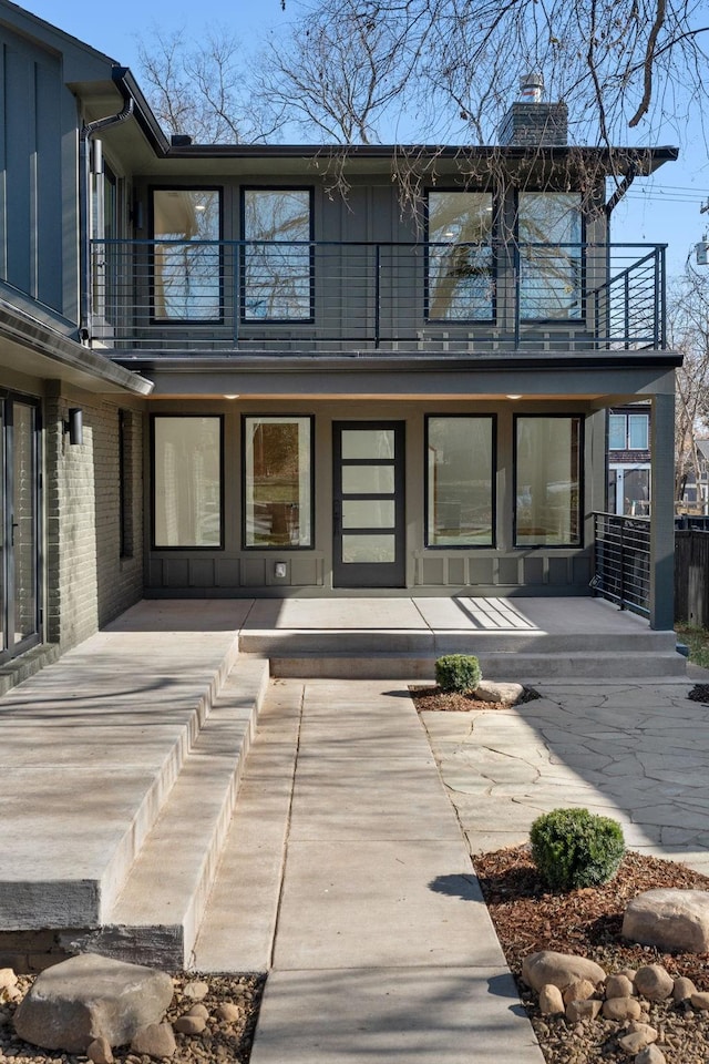 back of house with a patio and a balcony