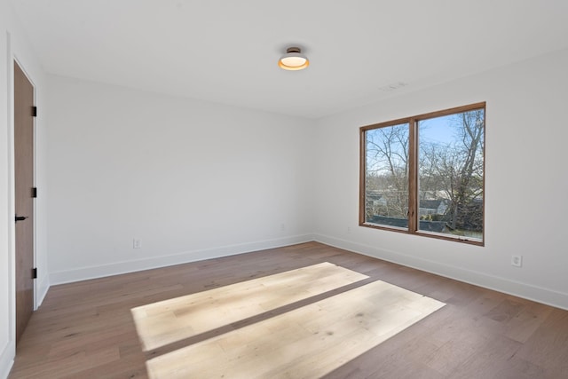 empty room with hardwood / wood-style flooring