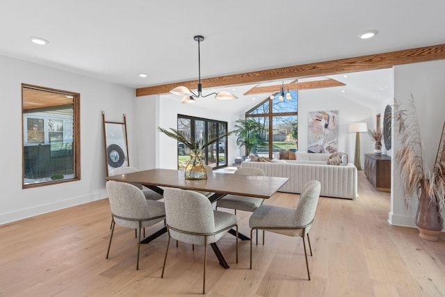 dining area featuring light hardwood / wood-style flooring, lofted ceiling with beams, and a chandelier