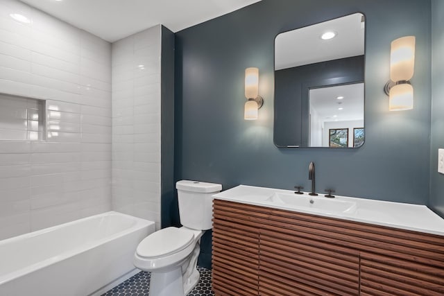 full bathroom featuring tile patterned floors, vanity, toilet, and tiled shower / bath combo