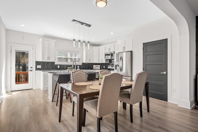 dining space featuring recessed lighting and light wood-style floors