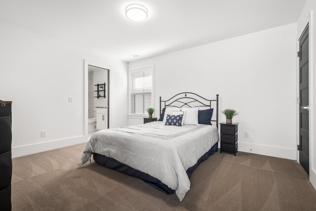 carpeted bedroom featuring baseboards and connected bathroom