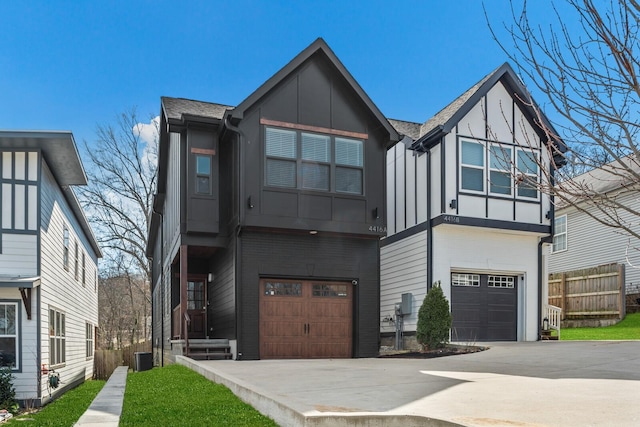 view of front of house featuring cooling unit, a garage, fence, driveway, and board and batten siding