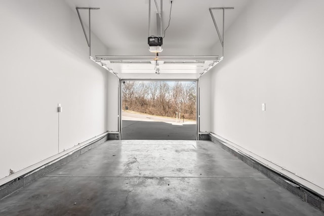 garage with baseboards and a garage door opener