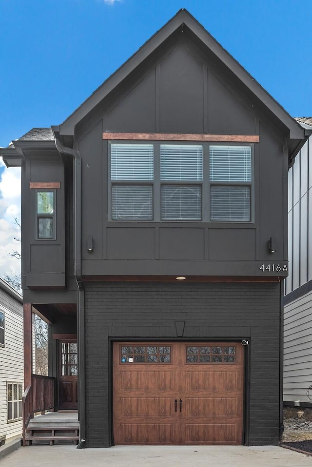 view of front of house with a garage and brick siding