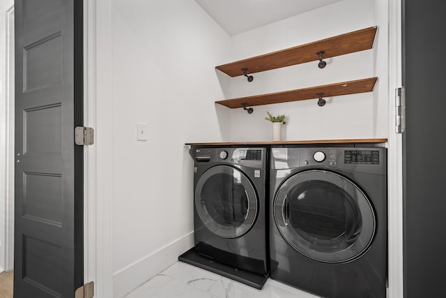 laundry area featuring marble finish floor, baseboards, laundry area, and separate washer and dryer