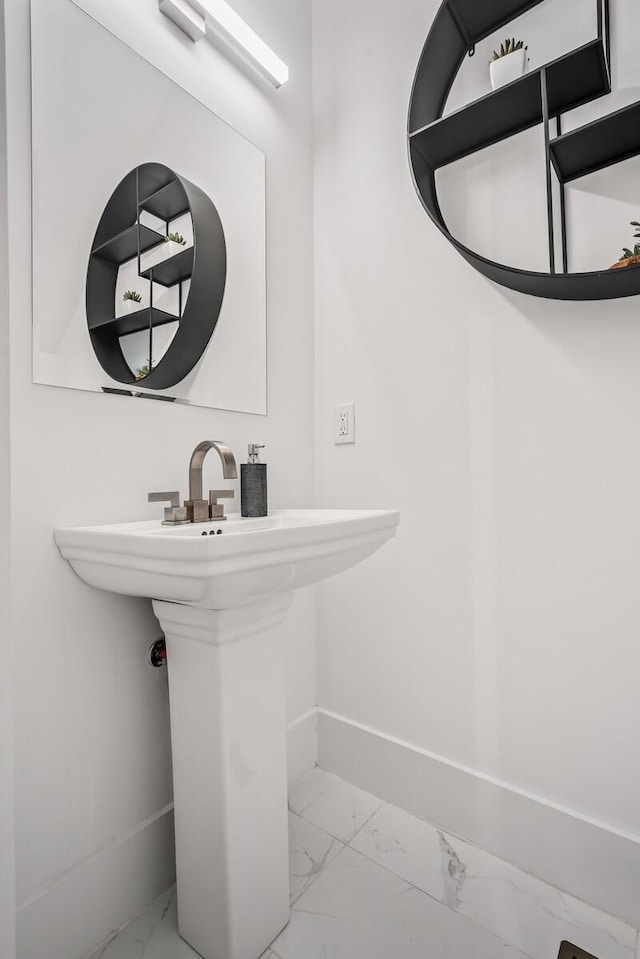 bathroom with marble finish floor and baseboards