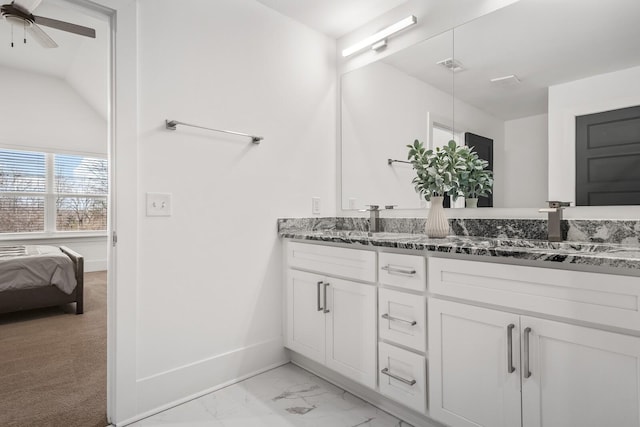 ensuite bathroom featuring double vanity, baseboards, visible vents, marble finish floor, and a sink