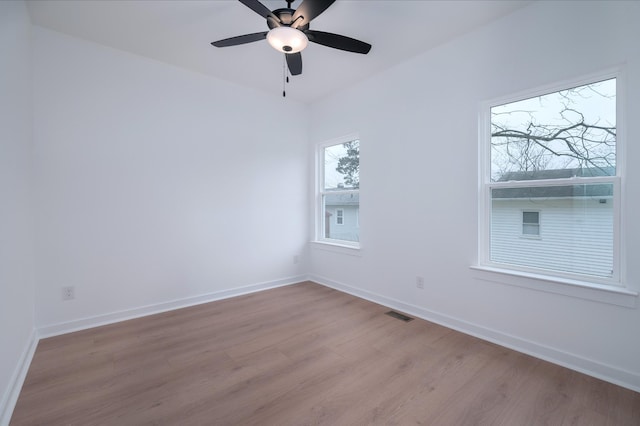 spare room featuring light hardwood / wood-style floors and ceiling fan