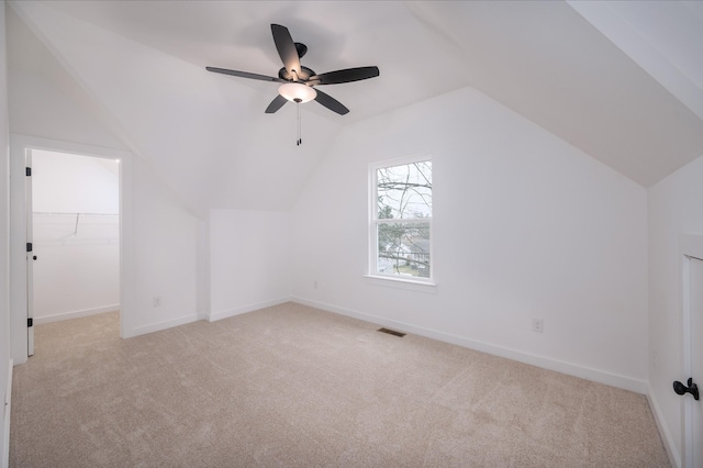 bonus room featuring lofted ceiling, light carpet, and ceiling fan