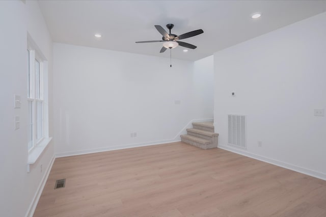 empty room with light hardwood / wood-style floors and ceiling fan