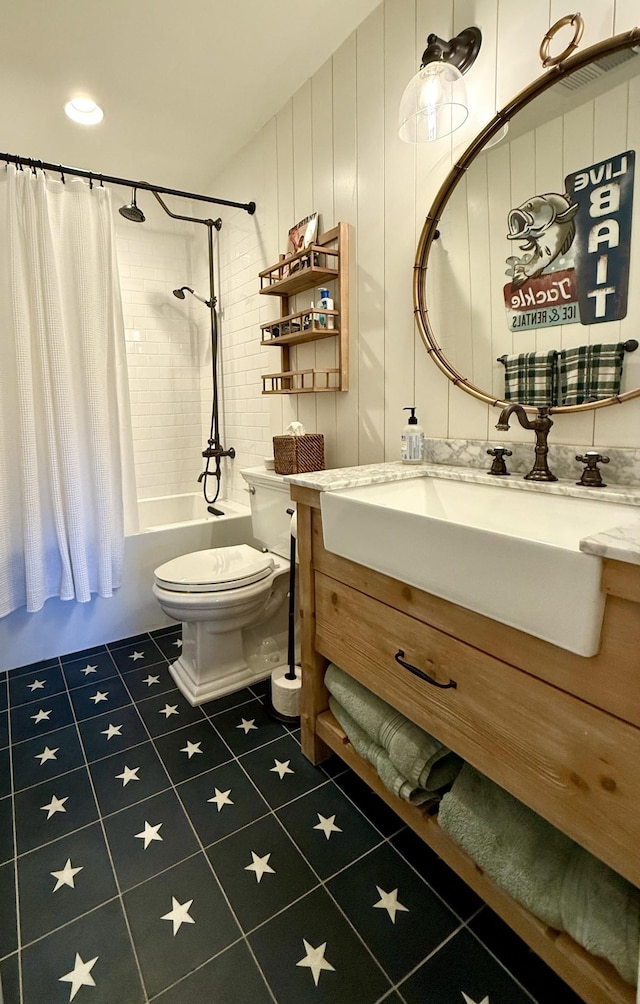 bathroom with vanity, tile patterned flooring, shower / bath combo with shower curtain, and toilet