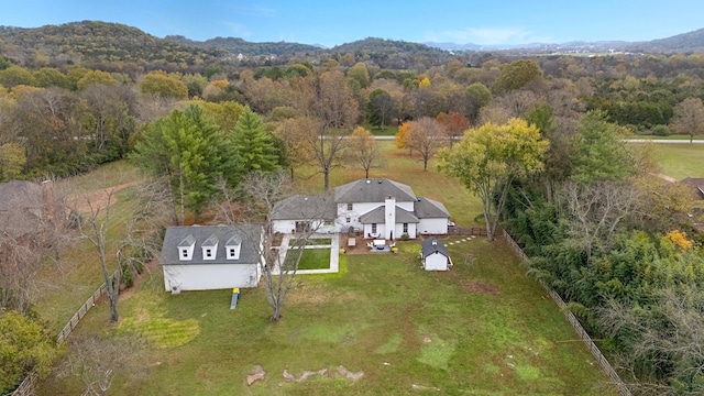 drone / aerial view featuring a forest view and a mountain view