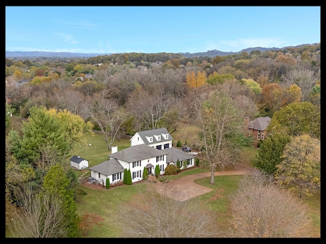 birds eye view of property with a view of trees