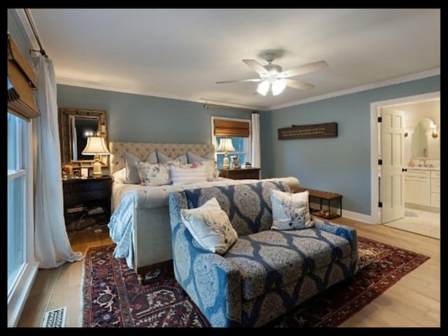 bedroom with visible vents, crown molding, and wood finished floors