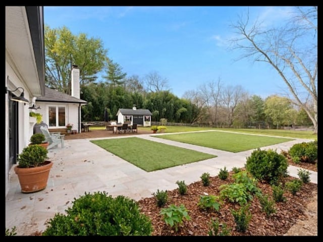 view of yard featuring a patio area and an outbuilding