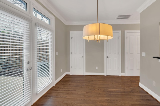 unfurnished dining area featuring ornamental molding and dark hardwood / wood-style floors