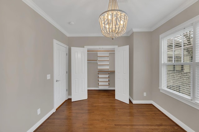 unfurnished bedroom with crown molding, a notable chandelier, dark hardwood / wood-style flooring, and a closet