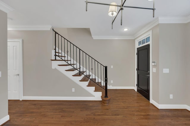 entrance foyer featuring ornamental molding and dark hardwood / wood-style floors