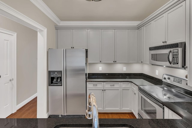 kitchen with ornamental molding, appliances with stainless steel finishes, dark wood-type flooring, and sink