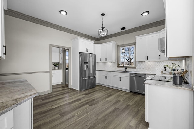 kitchen with stainless steel appliances, white cabinetry, hanging light fixtures, and sink