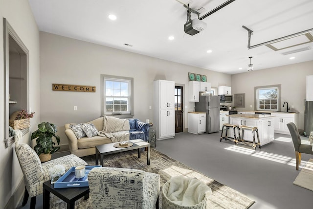 living room featuring sink and concrete floors