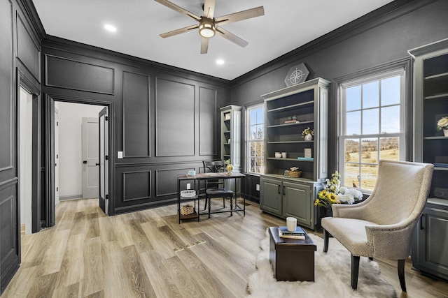 sitting room featuring ornamental molding, light hardwood / wood-style floors, and ceiling fan