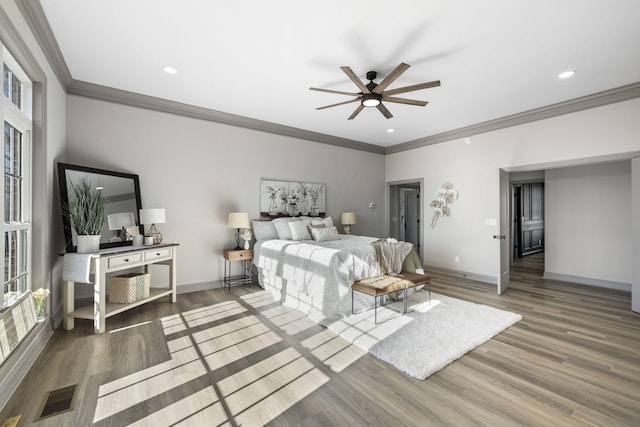 bedroom featuring crown molding, hardwood / wood-style flooring, and ceiling fan