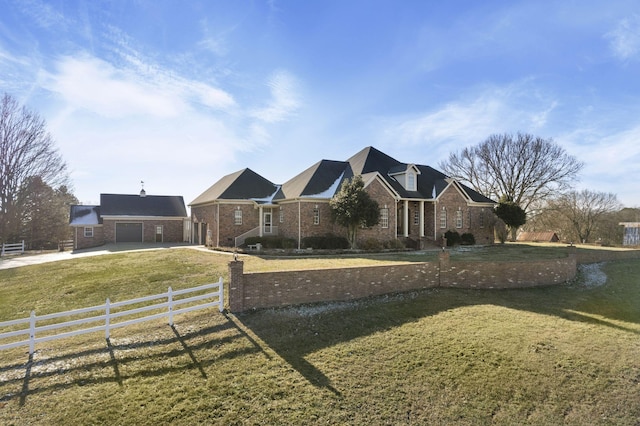 view of front of house featuring a garage and a front lawn