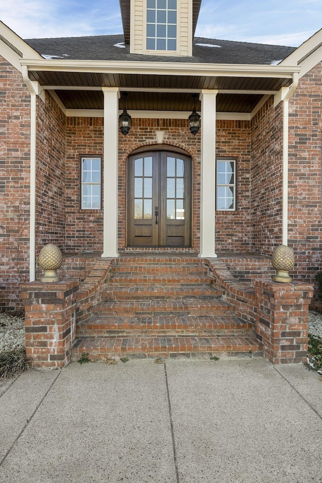 property entrance featuring a porch and french doors