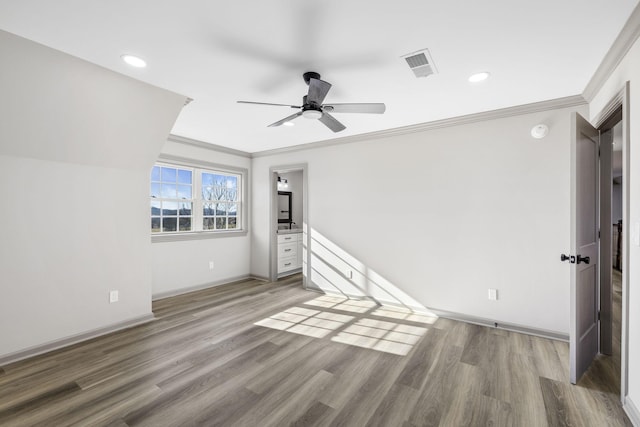 interior space with wood-type flooring, ornamental molding, and ceiling fan