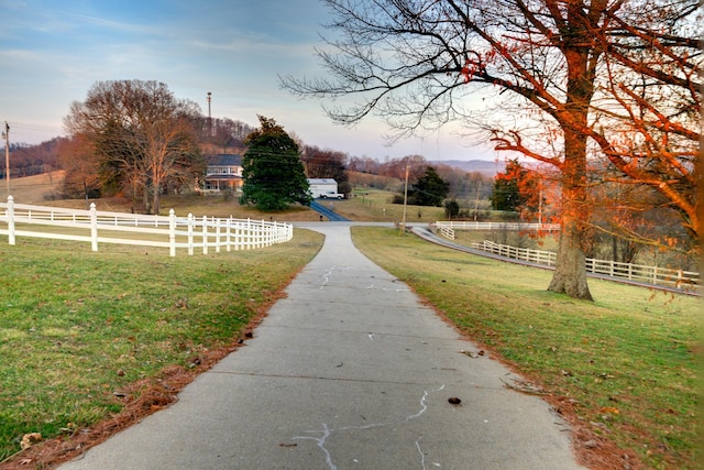 view of home's community featuring a rural view and a lawn