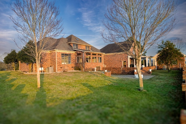 back of house featuring a yard and a patio area