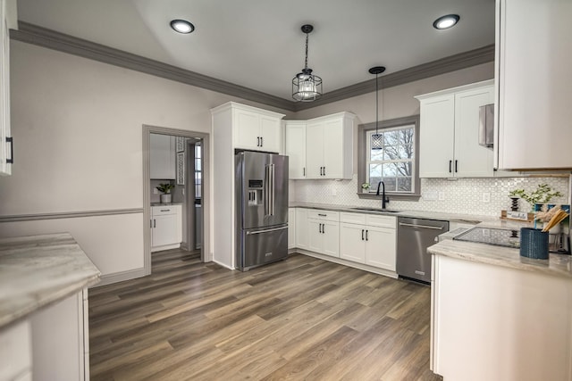 kitchen featuring pendant lighting, sink, white cabinets, stainless steel appliances, and dark wood-type flooring