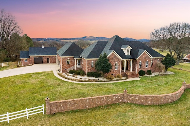 view of front facade featuring a garage and a lawn