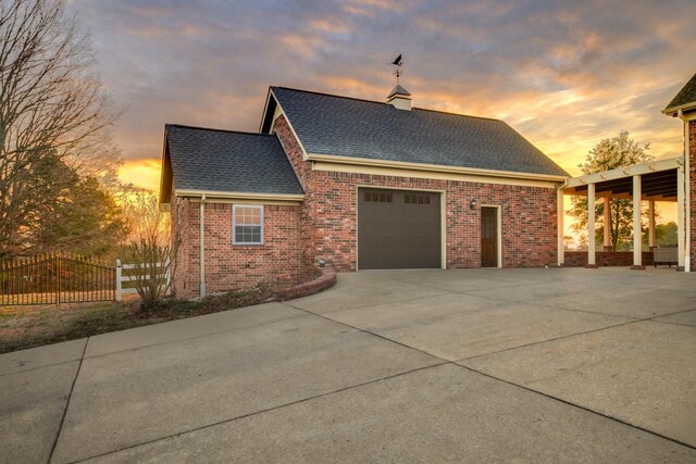 property exterior at dusk featuring a garage