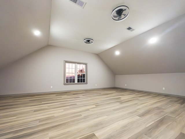 bonus room featuring vaulted ceiling and light wood-type flooring