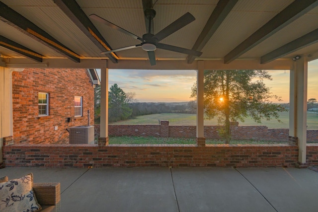 patio terrace at dusk with ceiling fan and central air condition unit