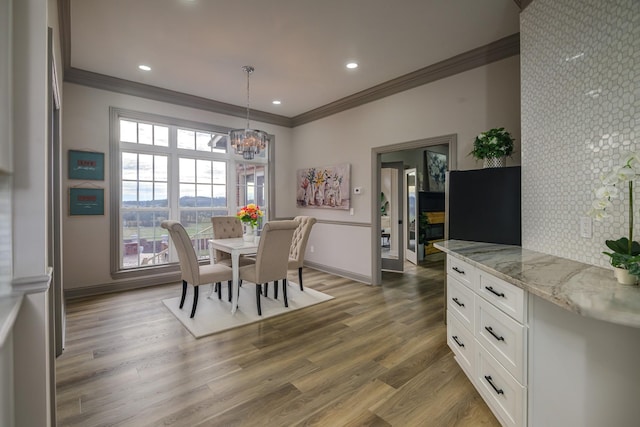 dining area featuring a notable chandelier, crown molding, and dark hardwood / wood-style floors