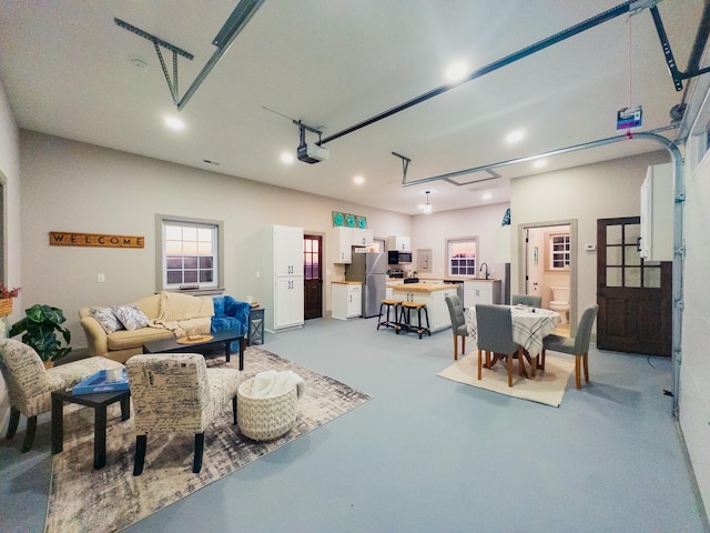garage featuring a garage door opener and stainless steel refrigerator