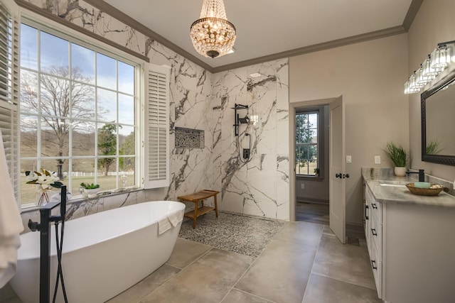 bathroom featuring vanity, ornamental molding, an inviting chandelier, and a bathtub
