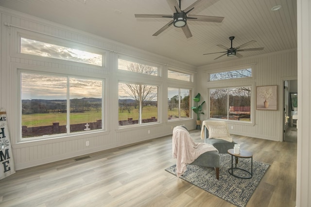 sunroom / solarium featuring ceiling fan