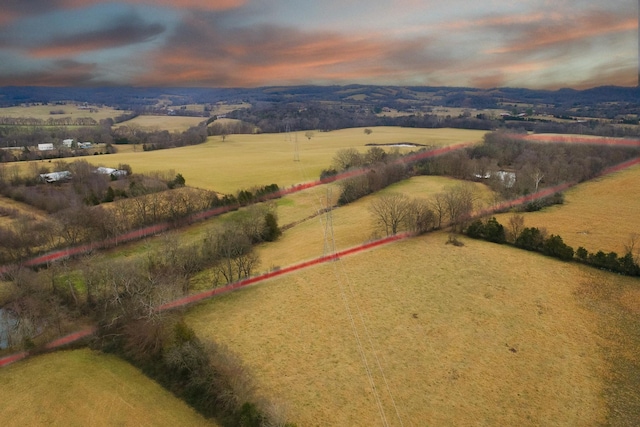 aerial view at dusk featuring a rural view