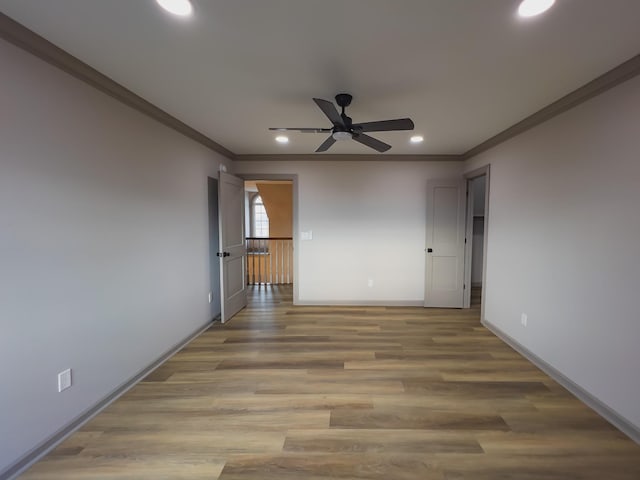 unfurnished room featuring hardwood / wood-style flooring, crown molding, and ceiling fan